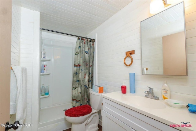 bathroom featuring vanity, a shower stall, toilet, and tile walls