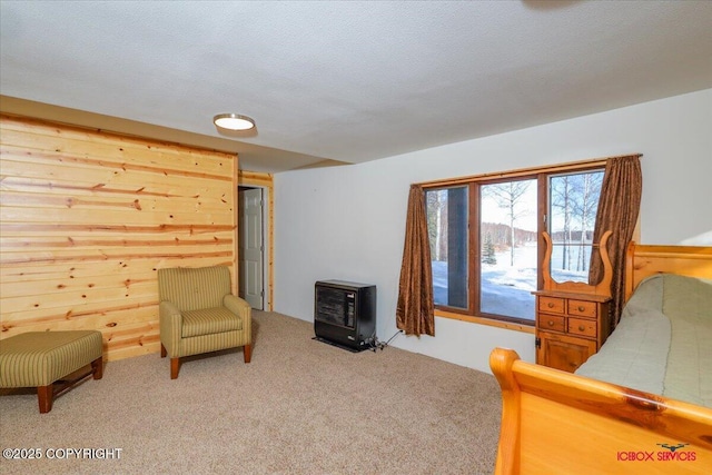 carpeted bedroom with a textured ceiling and wooden walls