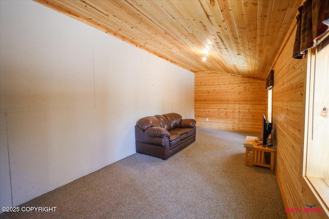 sitting room with wooden ceiling, wooden walls, carpet, and lofted ceiling