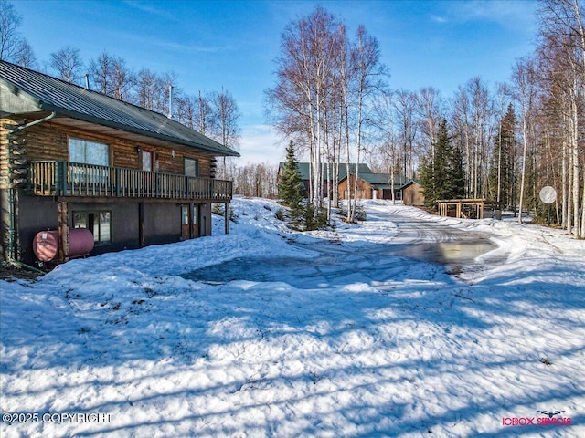 yard covered in snow featuring a wooden deck