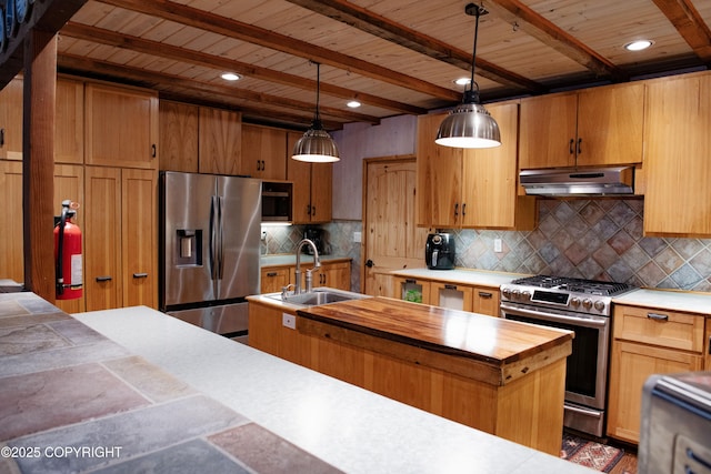 kitchen featuring beamed ceiling, under cabinet range hood, a sink, backsplash, and stainless steel appliances