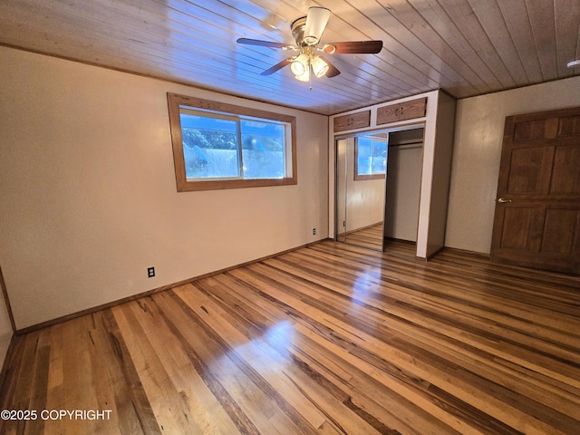 unfurnished bedroom with a closet, wood ceiling, and wood finished floors