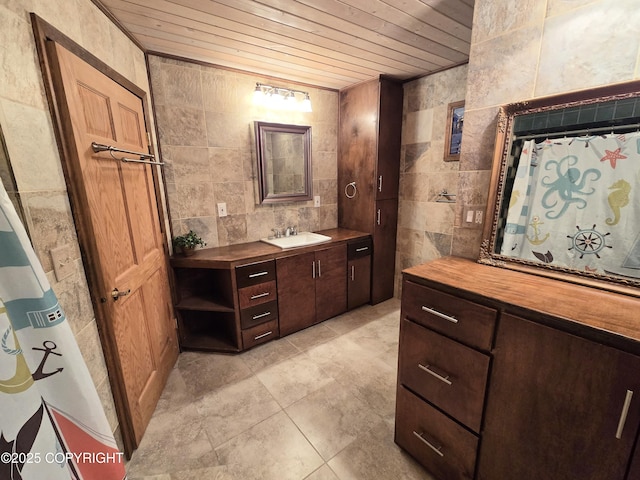 bathroom featuring vanity, tile walls, and wooden ceiling