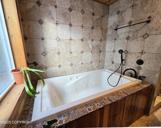 bathroom featuring tile walls, tile patterned flooring, and a tub with jets