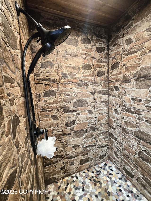 full bathroom with wood ceiling and a tile shower