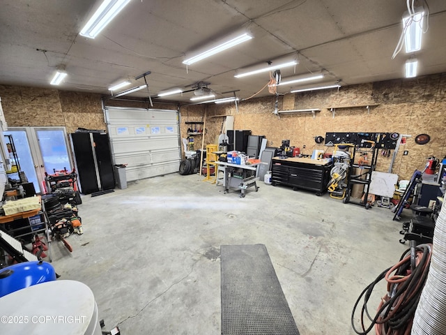 garage featuring a workshop area and a garage door opener