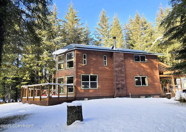 exterior space featuring a wooden deck and faux log siding