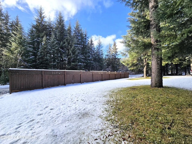 snowy yard with fence