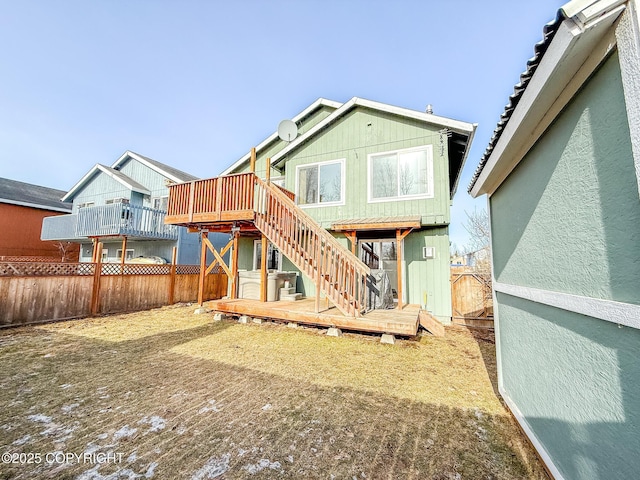 back of house with a deck, stairs, and fence