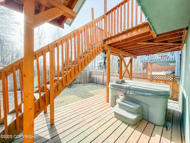 wooden deck with a hot tub