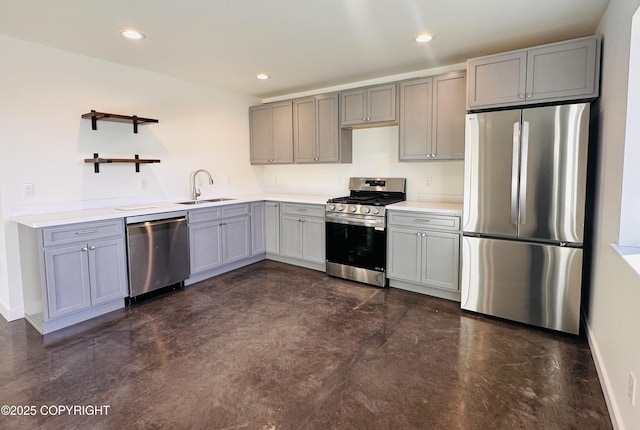 kitchen with gray cabinets, a sink, recessed lighting, appliances with stainless steel finishes, and baseboards