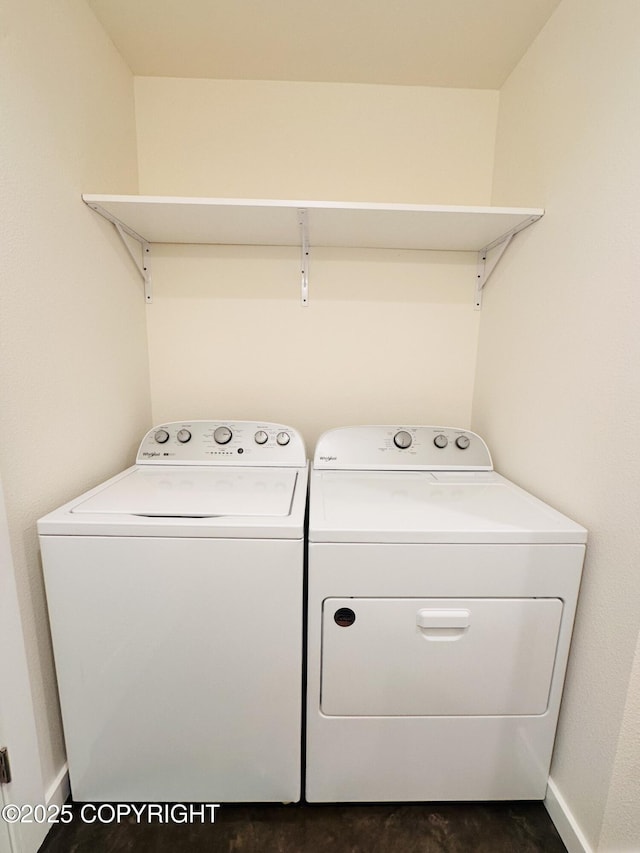 clothes washing area with laundry area, independent washer and dryer, and baseboards