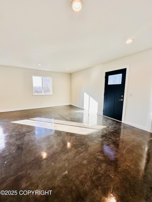 foyer with recessed lighting, baseboards, and finished concrete floors