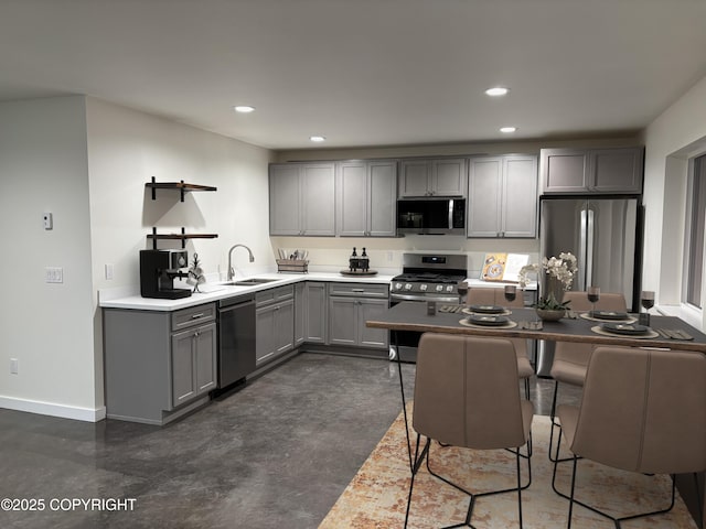 kitchen featuring a sink, appliances with stainless steel finishes, gray cabinetry, and recessed lighting