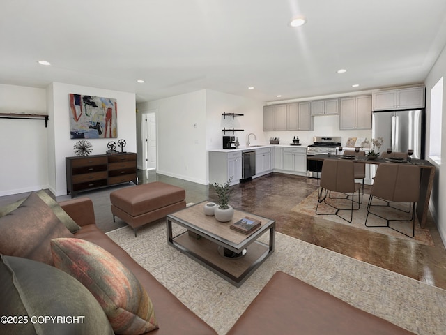 living room with concrete floors, baseboards, and recessed lighting
