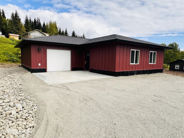 963 Nelson Ave, Homer, AK 99603 - view of property exterior with dirt driveway, an attached garage, and board and batten siding