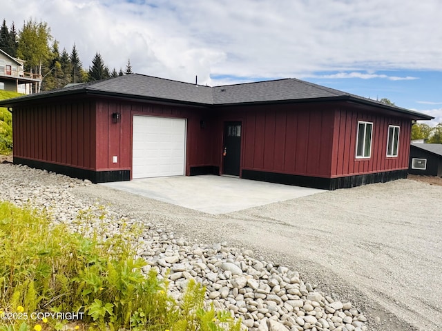 963 Nelson Ave, Homer, AK 99603 - view of property exterior with an attached garage, board and batten siding, driveway, and a shingled roof