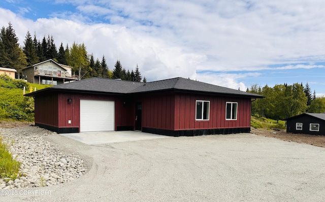 963 Nelson Ave, Homer, AK 99603 - view of front facade featuring board and batten siding, an attached garage, driveway, and roof with shingles