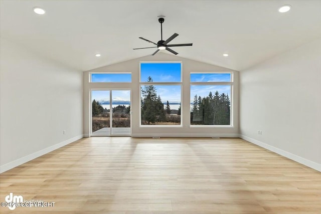 unfurnished living room featuring recessed lighting, light wood-type flooring, lofted ceiling, and baseboards