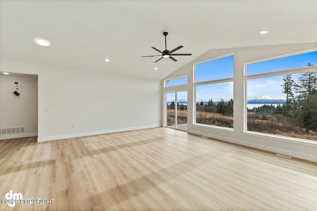 unfurnished living room featuring visible vents, baseboards, vaulted ceiling, recessed lighting, and light wood-style floors