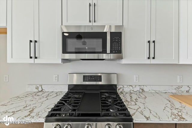 kitchen with white cabinetry and stainless steel appliances