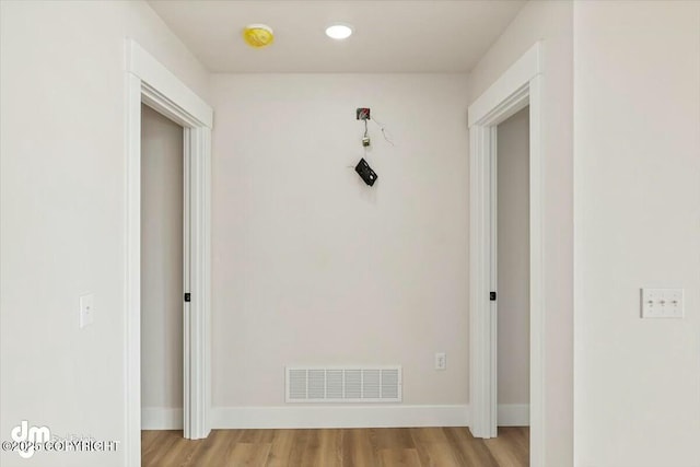 hall featuring recessed lighting, visible vents, light wood-style flooring, and baseboards