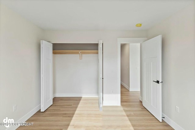 unfurnished bedroom featuring baseboards and light wood-style floors