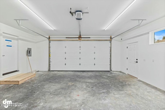 garage featuring electric panel and a garage door opener