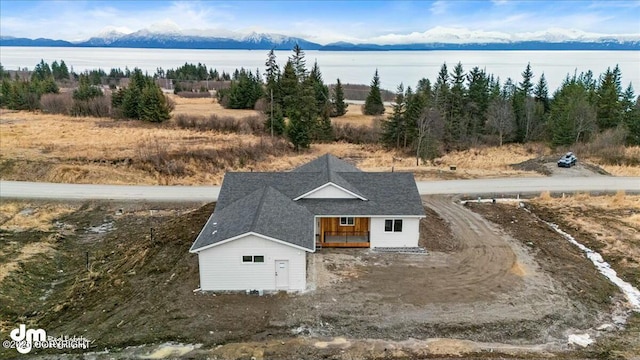 aerial view featuring a water and mountain view