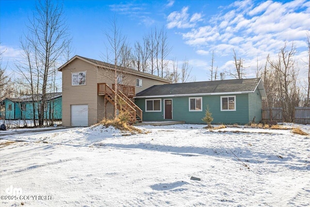 view of front of home with a garage and fence