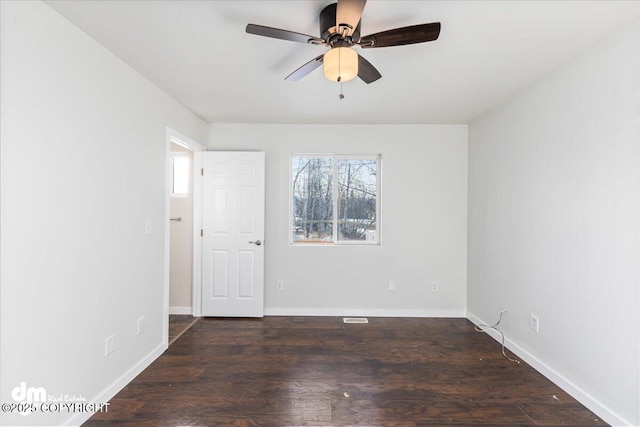 spare room with ceiling fan, baseboards, and wood finished floors