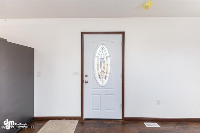 entryway with dark wood-style floors, visible vents, and baseboards