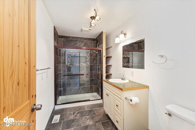 full bath featuring a stall shower, visible vents, vanity, and toilet