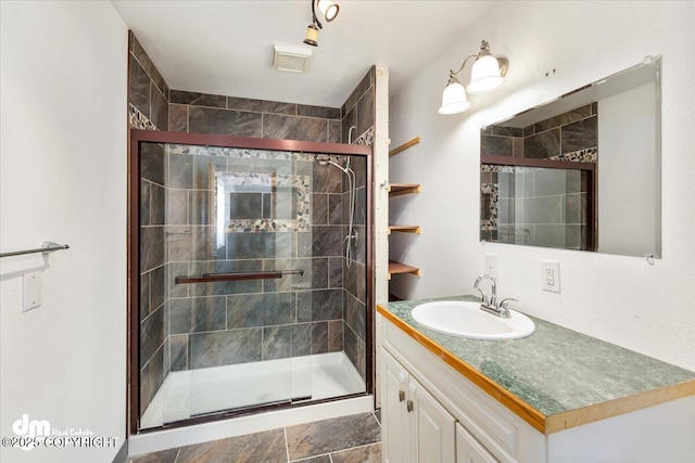 bathroom with a stall shower and vanity