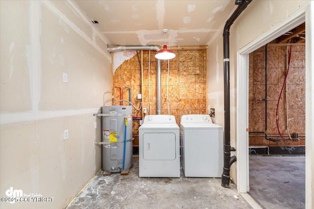 clothes washing area with laundry area, strapped water heater, and washer and dryer