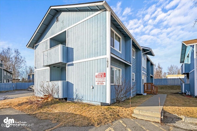 view of side of home with fence