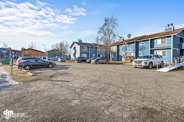 uncovered parking lot with a residential view