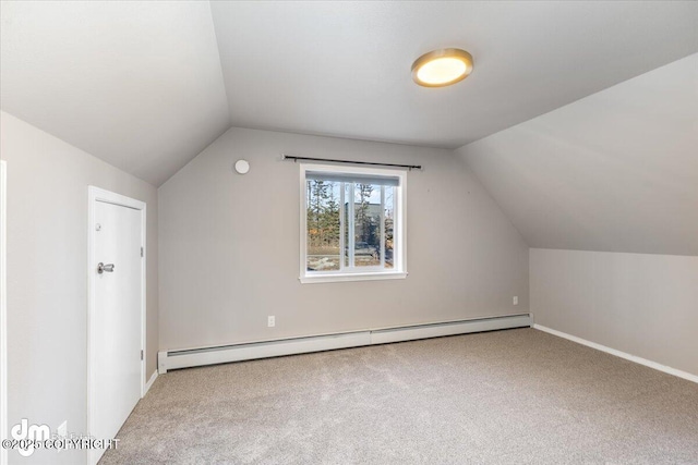 additional living space featuring carpet floors, baseboard heating, and vaulted ceiling