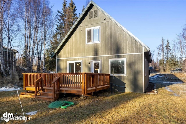 rear view of house featuring a wooden deck