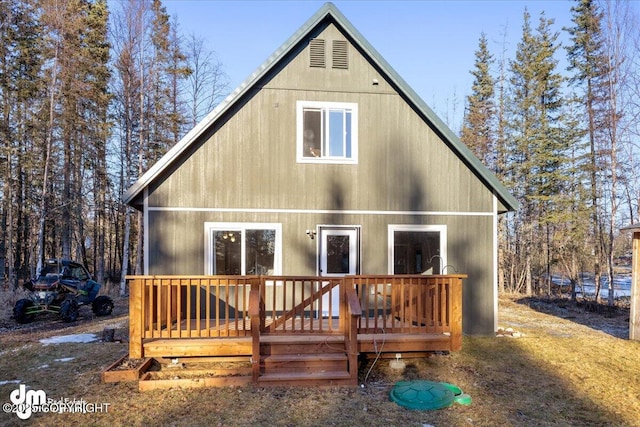 rear view of property featuring a deck