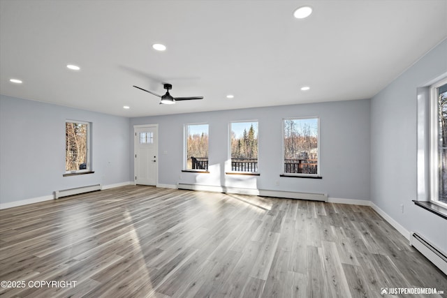 unfurnished living room featuring a baseboard heating unit, recessed lighting, wood finished floors, and a baseboard radiator