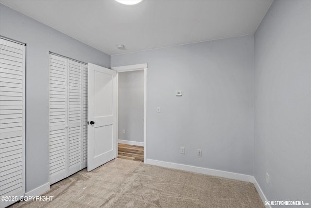 unfurnished bedroom with baseboards and carpet