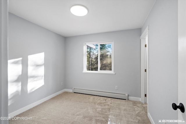 carpeted spare room featuring baseboards and a baseboard radiator