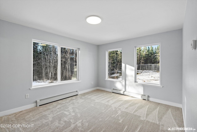 spare room featuring a baseboard radiator, carpet floors, baseboards, and a baseboard heating unit