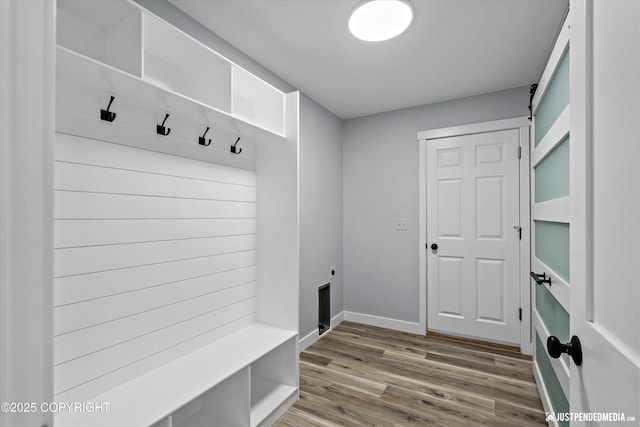 mudroom featuring baseboards and wood finished floors