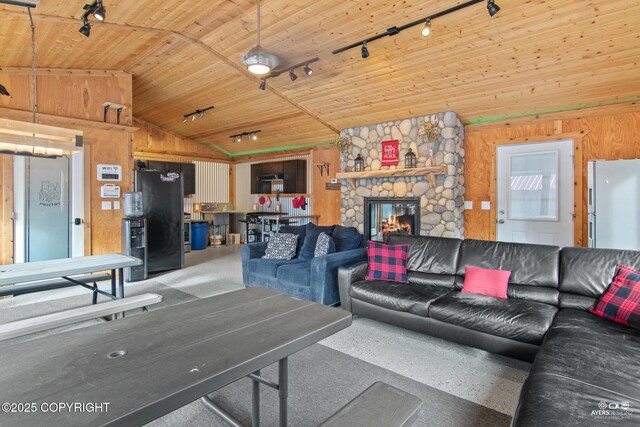 35376 Betty Lou Dr, Sterling, AK 99672 - living room featuring wooden walls, wood ceiling, a stone fireplace, and vaulted ceiling