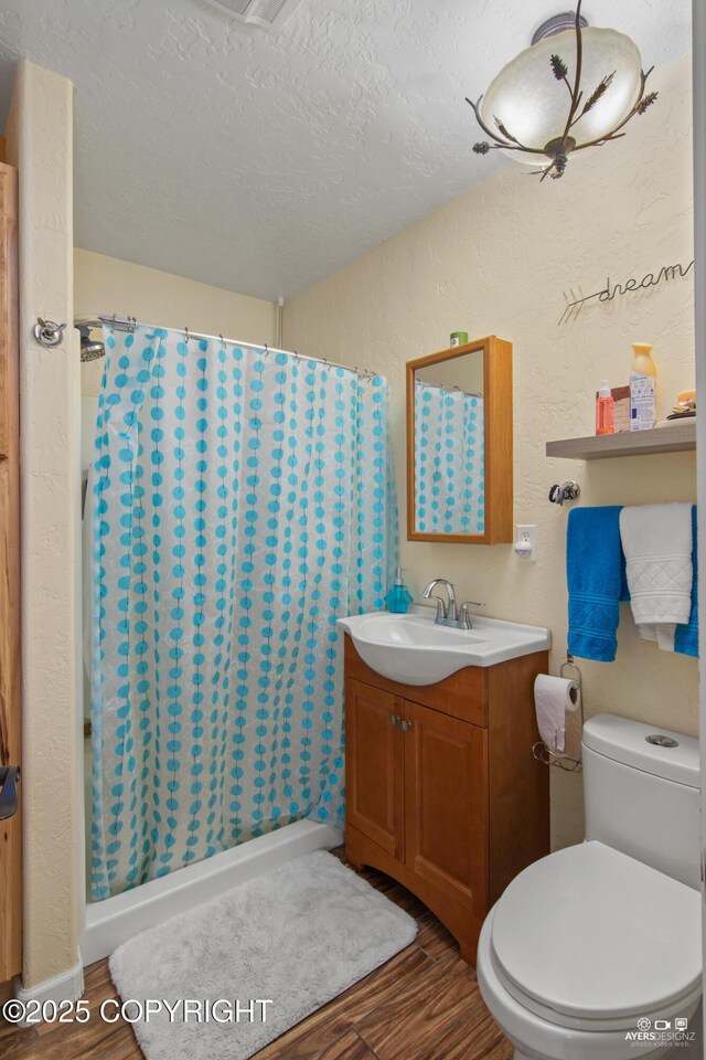 35376 Betty Lou Dr, Sterling, AK 99672 - full bath featuring curtained shower, toilet, wood finished floors, and vanity