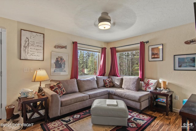 35376 Betty Lou Dr, Sterling, AK 99672 - living room featuring baseboards, wood finished floors, a textured wall, a textured ceiling, and a ceiling fan