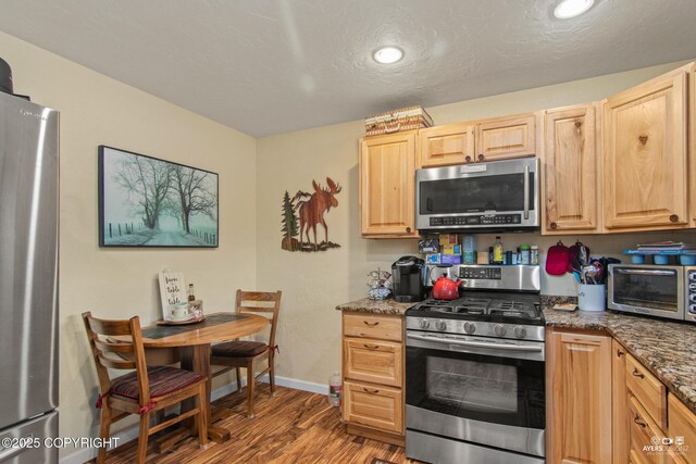 35376 Betty Lou Dr, Sterling, AK 99672 - kitchen with light brown cabinetry, a toaster, appliances with stainless steel finishes, and wood finished floors
