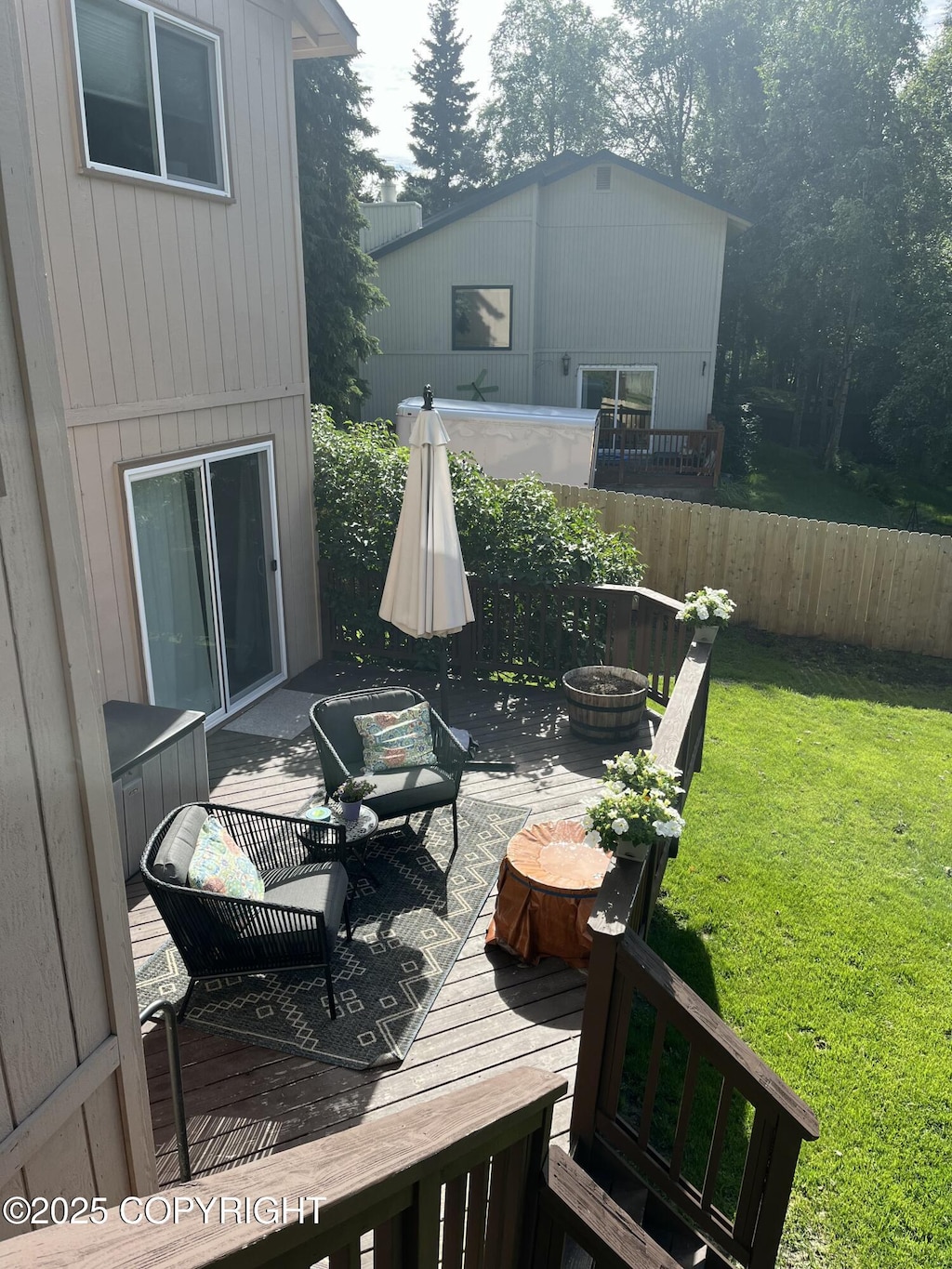 deck with a lawn, an outdoor hangout area, and fence